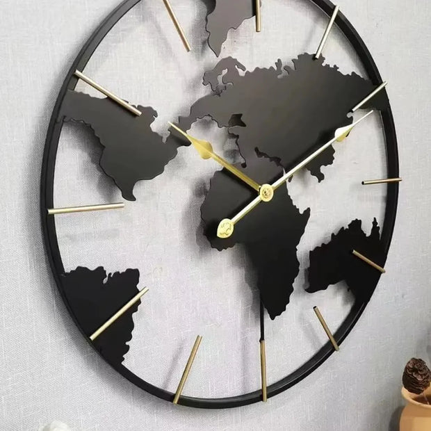 World Map Wall Clock - Harmonie: A 23.6 black metal clock with continent silhouettes and gold-tone markers, elegantly mounted above a tabletop with a statuette, perfect for sophisticated living spaces.